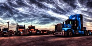 HDR Photo of an American Truck Road Train driving throug a Canyon desert Landscape, blue sky w...jpg
